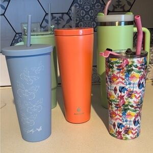 5 tumblers with lids and straws with 3 of them being stainless steel inside